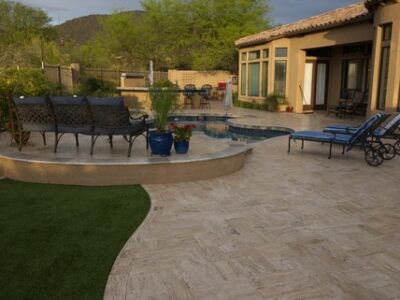 A,desert,landscaped,backyard,in,arizona,featuring,a,travertine,tiled