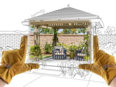 Male,contractor,hands,framing,completed,section,of,custom,pergola,patio